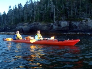 This is an Image of the author and her family in a Kayak paddling on the ocean.